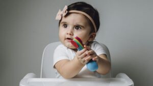 baby playing in baby chair